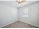 A bedroom with a ceiling fan, neutral walls, and wood-look tile floors at 12351 Ridgedale Dr, Hudson, FL 34669
