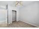 A bedroom with a ceiling fan, closet, and wood-look tile floors at 12351 Ridgedale Dr, Hudson, FL 34669