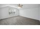Main bedroom with vaulted ceiling, blinds on windows, and wood-look tile flooring at 12351 Ridgedale Dr, Hudson, FL 34669