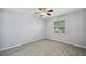 This bedroom features tile floors and a large window for natural light at 12351 Ridgedale Dr, Hudson, FL 34669
