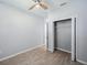 A bedroom features a ceiling fan, closet, and wood-look tile floors at 12351 Ridgedale Dr, Hudson, FL 34669