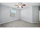This bedroom features tile floors and a large window overlooking backyard lake at 12351 Ridgedale Dr, Hudson, FL 34669