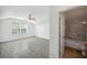 Main bedroom with bathroom access, vaulted ceiling, blinds on windows, wood-look tile at 12351 Ridgedale Dr, Hudson, FL 34669