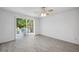 Bright bedroom with tile floors and sliding glass doors to the patio at 12351 Ridgedale Dr, Hudson, FL 34669