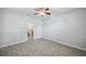 A spacious bedroom features wood-look tile floors, a ceiling fan, and an ensuite bathroom at 12351 Ridgedale Dr, Hudson, FL 34669