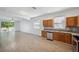Open kitchen with wooden cabinets, granite countertops, and seamless flow to the living area at 12351 Ridgedale Dr, Hudson, FL 34669