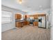 Bright kitchen features stainless steel appliances, granite countertops and wood cabinets at 12351 Ridgedale Dr, Hudson, FL 34669