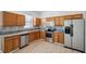 Well-equipped kitchen featuring wood cabinets, stainless steel appliances, and granite countertops at 12351 Ridgedale Dr, Hudson, FL 34669