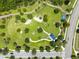Aerial view of community green space featuring walking paths, playground, and picnic area at 17537 Brighton Lake Rd, Land O Lakes, FL 34638