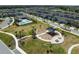 Community aerial view featuring a park, playground, pool, and well-maintained neighborhood streets at 17537 Brighton Lake Rd, Land O Lakes, FL 34638