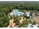 Aerial view of a community featuring a playground, fire pit, and a resort-style pool surrounded by trees at 17537 Brighton Lake Rd, Land O Lakes, FL 34638