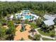 Aerial view of community pool and playground surrounded by lush landscaping and mature trees at 17537 Brighton Lake Rd, Land O Lakes, FL 34638