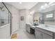 Bright bathroom featuring double sinks, vanity, and glass-enclosed shower with tile accents at 17537 Brighton Lake Rd, Land O Lakes, FL 34638