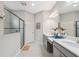 Bathroom with double vanity sinks, a large mirror, and a glass-enclosed shower at 17537 Brighton Lake Rd, Land O Lakes, FL 34638