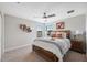 Bedroom with a ceiling fan, windows, a bed with decorative pillows, and bedside tables at 17537 Brighton Lake Rd, Land O Lakes, FL 34638