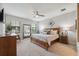 Bedroom with a large bed, dresser, mirrors, and natural light from windows at 17537 Brighton Lake Rd, Land O Lakes, FL 34638