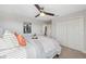 Bedroom featuring a ceiling fan, double closets, and a comfortable bed with decorative pillows at 17537 Brighton Lake Rd, Land O Lakes, FL 34638