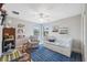 Bedroom with a blue patterned rug, daybed, chair, and decorative wall art at 17537 Brighton Lake Rd, Land O Lakes, FL 34638