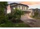 Charming two-story home with stone accents, a paved driveway, and lush landscaping at 17537 Brighton Lake Rd, Land O Lakes, FL 34638