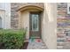 Charming front door featuring decorative glass, stone accents, and a welcoming 'Hello' doormat at 17537 Brighton Lake Rd, Land O Lakes, FL 34638