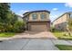 Beautiful home with a brick driveway, two-car garage, stone accents, and well-maintained landscaping at 17537 Brighton Lake Rd, Land O Lakes, FL 34638