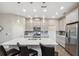 Contemporary kitchen with island, breakfast bar, stainless steel appliances, and white cabinets at 17537 Brighton Lake Rd, Land O Lakes, FL 34638