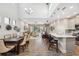 Spacious open-concept living area featuring a dining table, island seating, and a seamless flow to the outdoor patio at 17537 Brighton Lake Rd, Land O Lakes, FL 34638