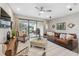 Comfortable living room with a leather sofa, patterned rug, and sliding glass doors to the backyard patio at 17537 Brighton Lake Rd, Land O Lakes, FL 34638