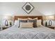 Close-up of main bedroom bed with decorative pillows and nightstands with lamps at 17537 Brighton Lake Rd, Land O Lakes, FL 34638