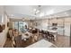 Open-concept living space with a dining area, living room, and kitchen with a center island and bar seating at 17537 Brighton Lake Rd, Land O Lakes, FL 34638