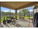 Enclosed patio with comfortable seating, an outdoor bar, and a view of the backyard at 17537 Brighton Lake Rd, Land O Lakes, FL 34638