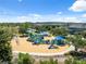 Community playground with modern equipment, mature trees, and manicured landscaping at 17537 Brighton Lake Rd, Land O Lakes, FL 34638