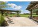 Outdoor shaded seating area with swings and benches, perfect for relaxation at 17537 Brighton Lake Rd, Land O Lakes, FL 34638