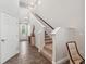 Bright entryway with elegant staircase, featuring tile flooring and a decorative console table for a grand welcome at 17537 Brighton Lake Rd, Land O Lakes, FL 34638