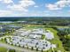 Aerial view of a large school campus with sports fields, parking lots, and surrounding residential area at 18172 Ramble On Way, Land O Lakes, FL 34638