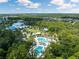 Aerial view of the community pools surrounded by lush greenery, offering a resort-like experience for residents at 18172 Ramble On Way, Land O Lakes, FL 34638
