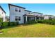 Lush backyard featuring a screened-in porch, healthy green grass, and privacy landscaping at 18172 Ramble On Way, Land O Lakes, FL 34638