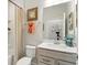 Well-lit bathroom with a shower, toilet, and sink vanity featuring elegant finishes at 18172 Ramble On Way, Land O Lakes, FL 34638
