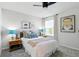 Comfortable bedroom showcases a bed with decorative pillows, side tables, lamps, and neutral decor at 18172 Ramble On Way, Land O Lakes, FL 34638