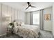 Inviting bedroom features a patterned comforter, a ceiling fan, and a bedside table with glass top at 18172 Ramble On Way, Land O Lakes, FL 34638