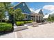 A clubhouse with blue siding, white trim, and well-maintained landscaping at 18172 Ramble On Way, Land O Lakes, FL 34638