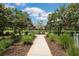 A charming community park with flowering trees lining the paved walkway at 18172 Ramble On Way, Land O Lakes, FL 34638