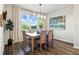 Dining area with a stylish table and chairs, natural light, and modern decor at 18172 Ramble On Way, Land O Lakes, FL 34638