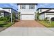 Charming two-story home featuring a two-car garage, brick driveway, and well-maintained landscaping at 18172 Ramble On Way, Land O Lakes, FL 34638