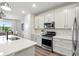 Stylish kitchen boasts white cabinets, stainless appliances, and sleek countertops at 18172 Ramble On Way, Land O Lakes, FL 34638