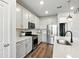 Modern kitchen featuring stainless steel appliances, white cabinets, and stylish countertops at 18172 Ramble On Way, Land O Lakes, FL 34638