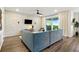 Stylish living room featuring modern lighting, a large sectional sofa, and a sliding glass door to the patio at 18172 Ramble On Way, Land O Lakes, FL 34638