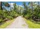 Secluded gravel walking path surrounded by lush greenery and trees, perfect for nature lovers at 18172 Ramble On Way, Land O Lakes, FL 34638