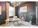 Home office featuring dark walls, a window, and elegant decor at 18172 Ramble On Way, Land O Lakes, FL 34638