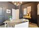 Dark-walled office with natural lighting and a clean and modern aesthetic at 18172 Ramble On Way, Land O Lakes, FL 34638